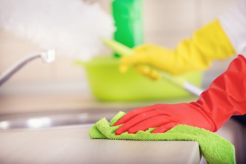 Professional cleaners maintaining desks and shared office surfaces